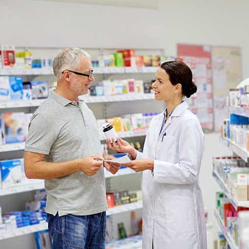Pharmacist giving patient advice on medication.