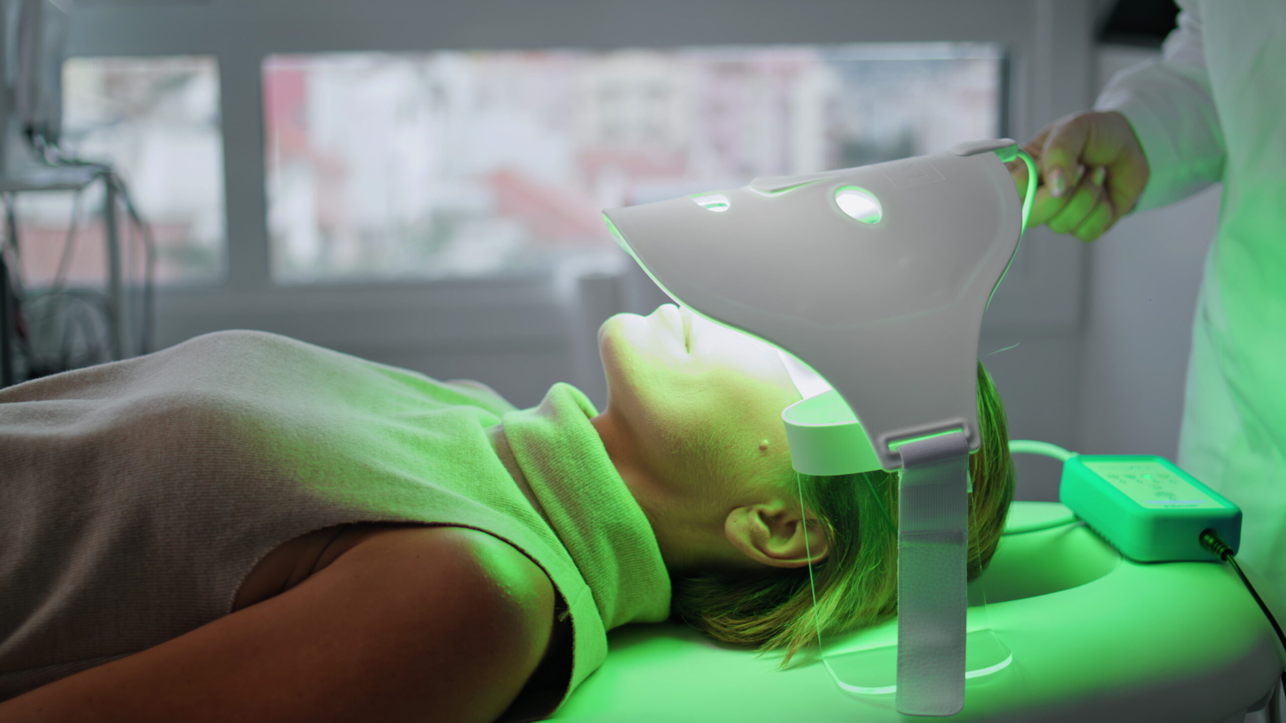 Woman having led therapy for regeneration face skin in beauty clinic